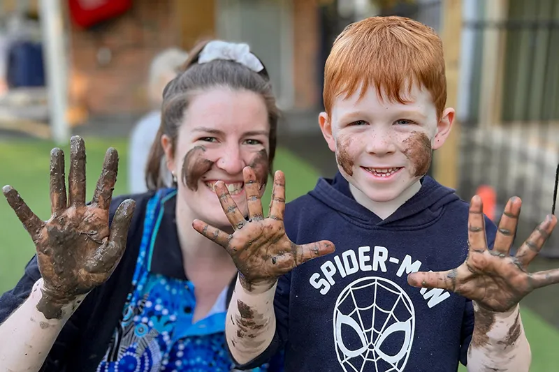 Early Childhood Educator and preschool child enjoying messy play
